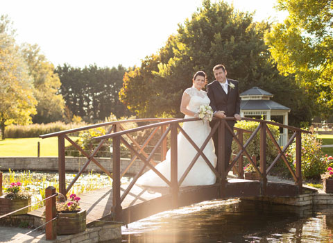 Wedding Photographer image of bride and groom on a bridge
